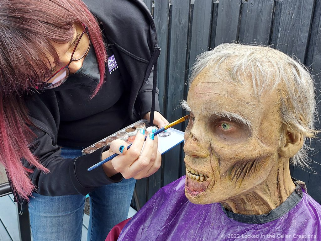 Desiree is putting some finishing touches on a zombie make-up for the upcoming horror anthology Grief.